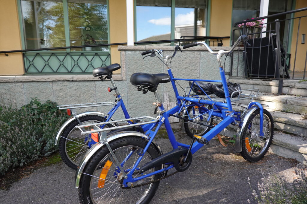 En blå dubbelcykel med möjlighet att cykla två bredvid varandra