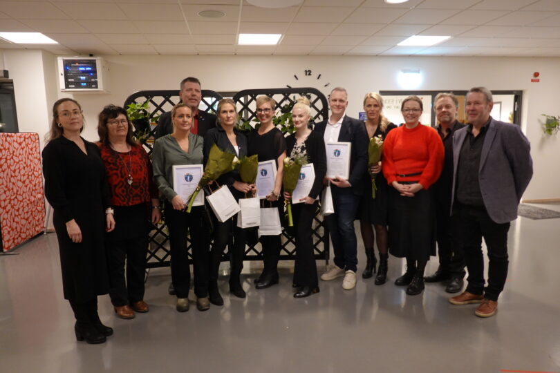 Gruppbild på pristagare och kommunpolitiker vid utdelning av kommunens priser under kommunfullmäktiges sammanträde december 2023.
