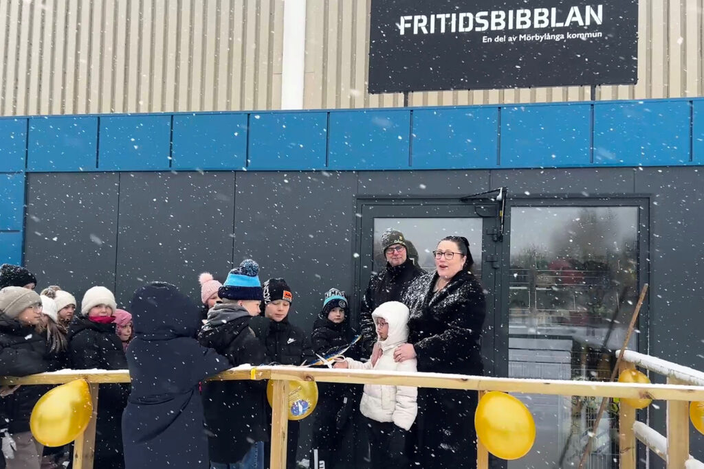 Politiker och skolbarn inviger nya Fritidsbibblan med bandklippning och ballonger.
